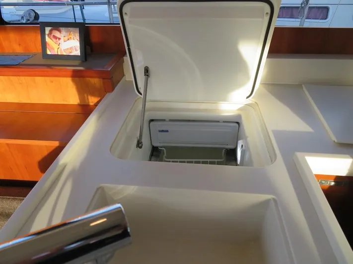  Yacht Photos Pics Open storage compartment on 2018 Moody 54 DS yacht interior.