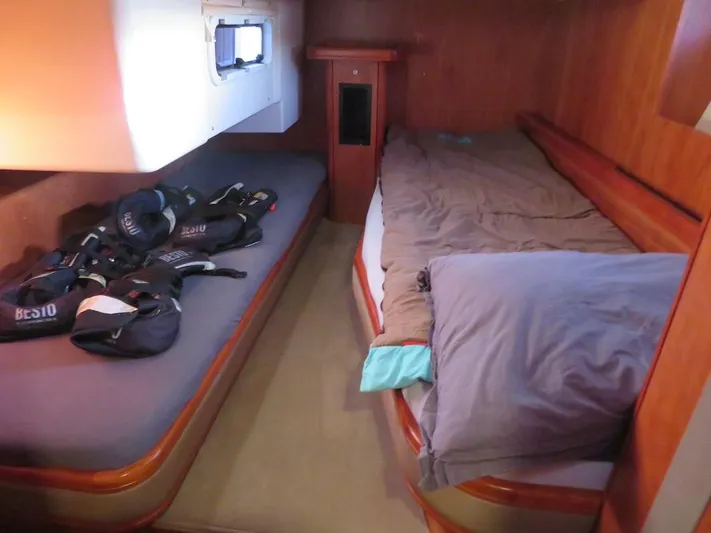 Yacht Photos Pics Cozy cabin interior of 2018 Moody 54 DS yacht with twin beds and sailing gear.