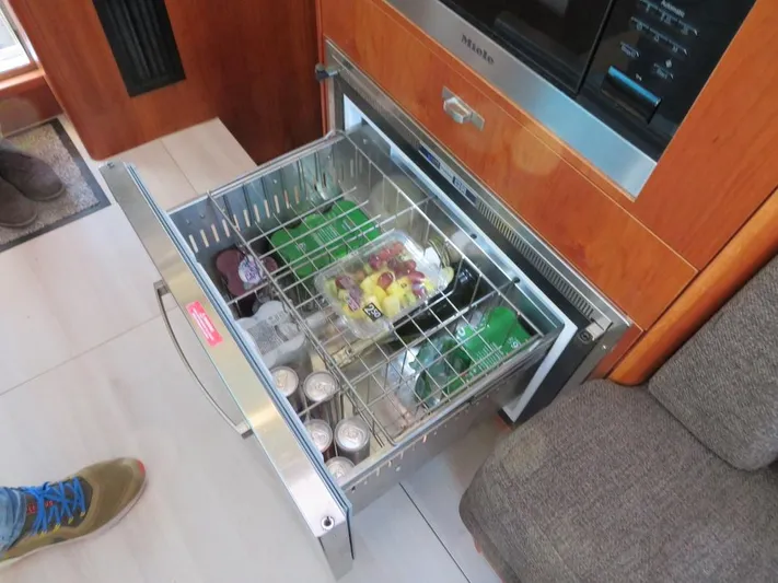  Yacht Photos Pics Open drawer refrigerator on Moody 54 DS yacht, stocked with beverages and snacks.