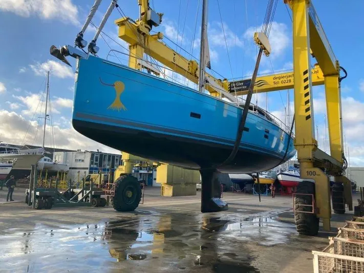  Yacht Photos Pics Sailboat Moody 54 DS 2018 in dry dock, vibrant blue hull, under maintenance.