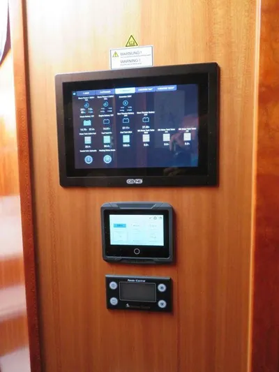 Yacht Photos Pics Control panel on 2018 Moody 54 DS yacht, featuring digital displays and warning sign.