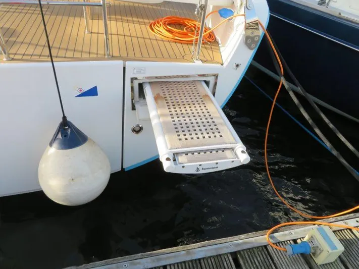  Yacht Photos Pics Sailboat stern with retractable gangway, Moody 54 DS, 2018 model, docked with fender and cables.