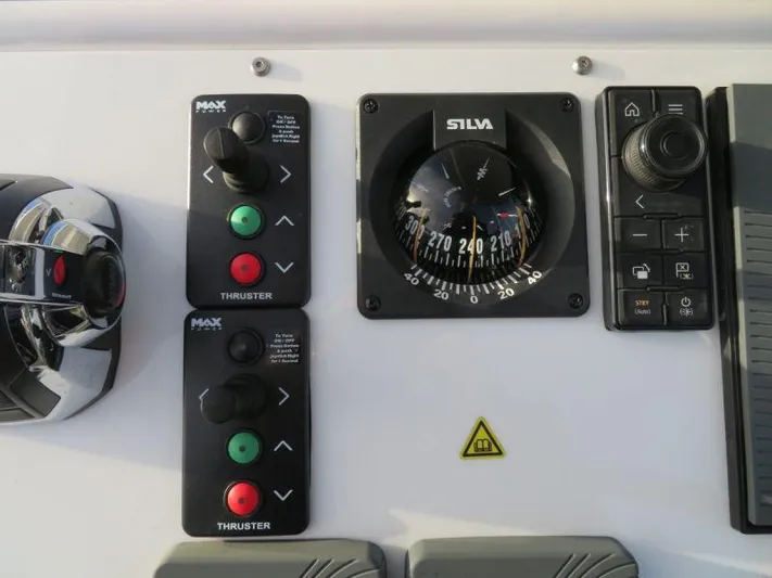  Yacht Photos Pics Control panel of a 2018 Moody 54 DS yacht with compass and thruster controls.