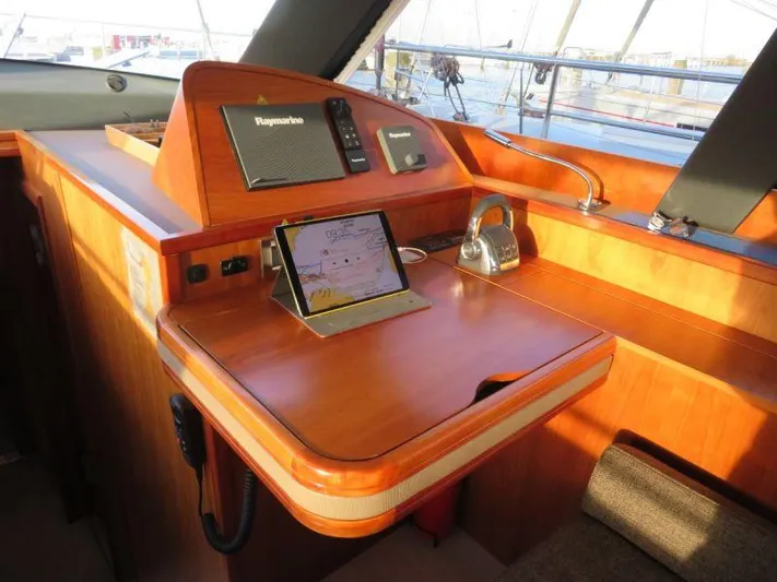  Yacht Photos Pics Navigation station on 2018 Moody 54 DS yacht with electronic equipment and wooden finish.