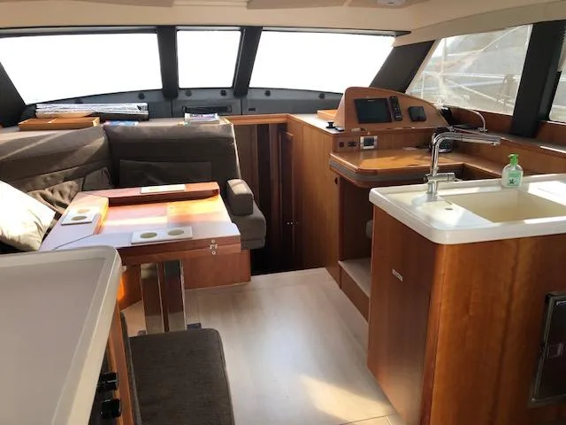  Yacht Photos Pics Luxurious interior of 2018 Moody 54 DS yacht with modern kitchen and seating area.