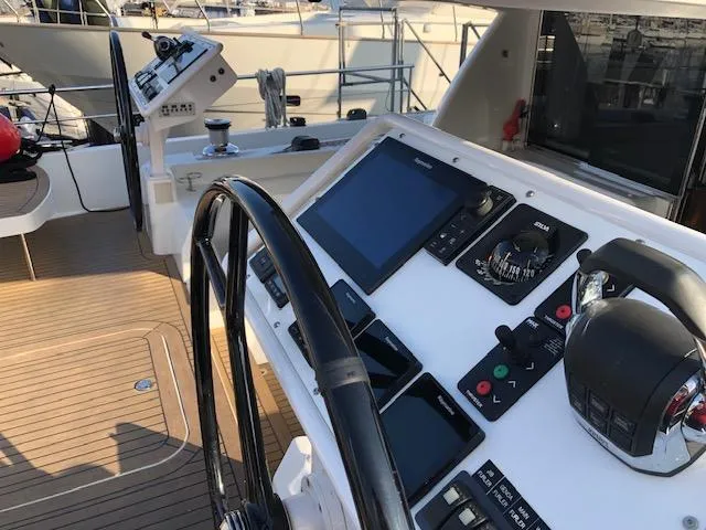  Yacht Photos Pics Cockpit of 2018 Moody 54 DS yacht with navigation controls and steering wheel.