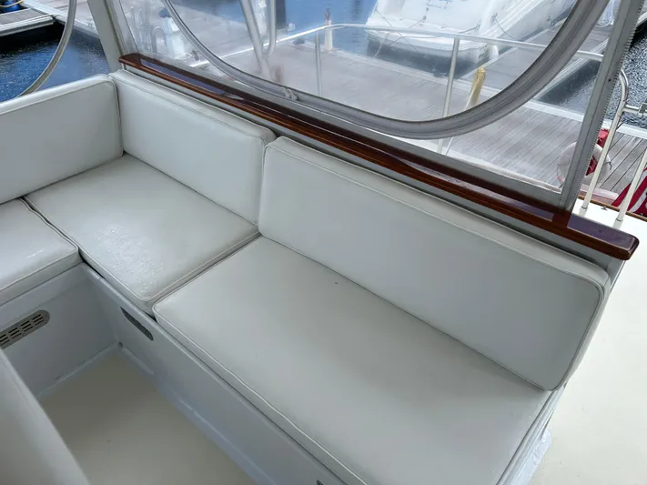 From Away Yacht Photos Pics 1987 Lyman-Morse Downeast Flybridge interior with white cushioned seating.