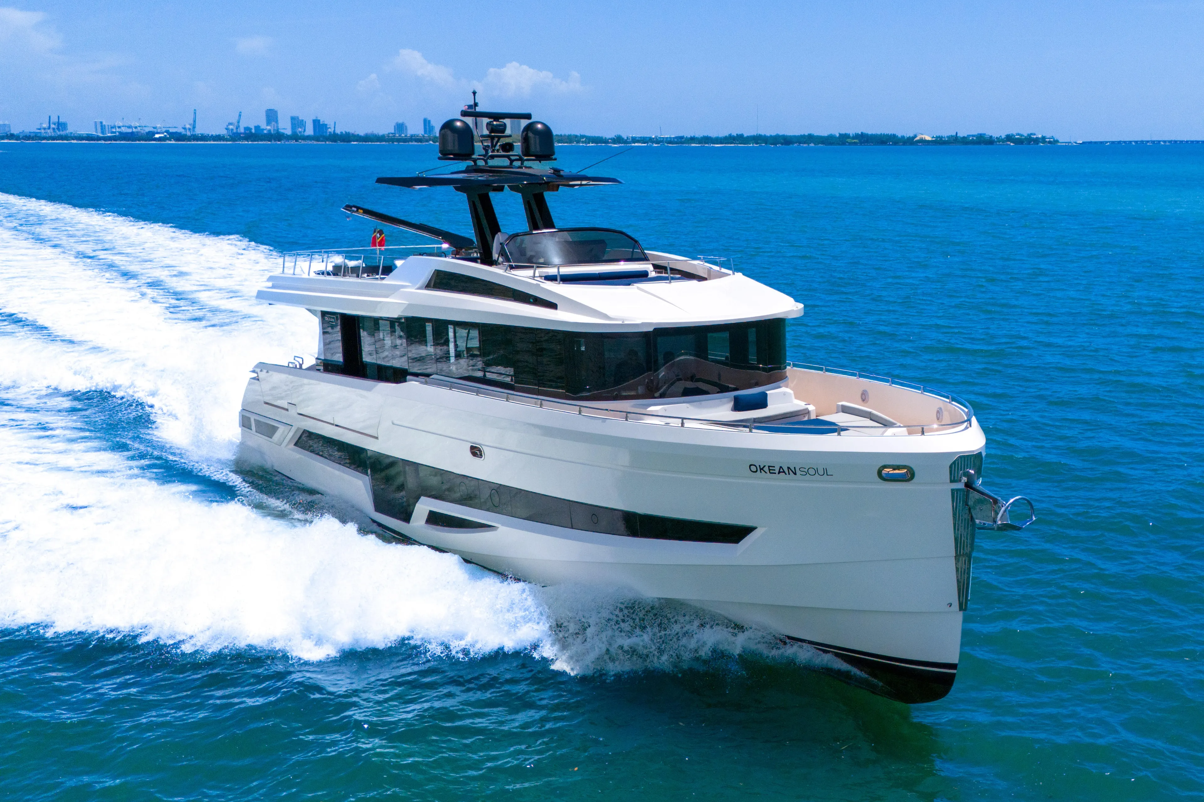  Yacht Photos Pics Luxury 2021 OKEAN 80 yacht cruising on blue ocean near city skyline.