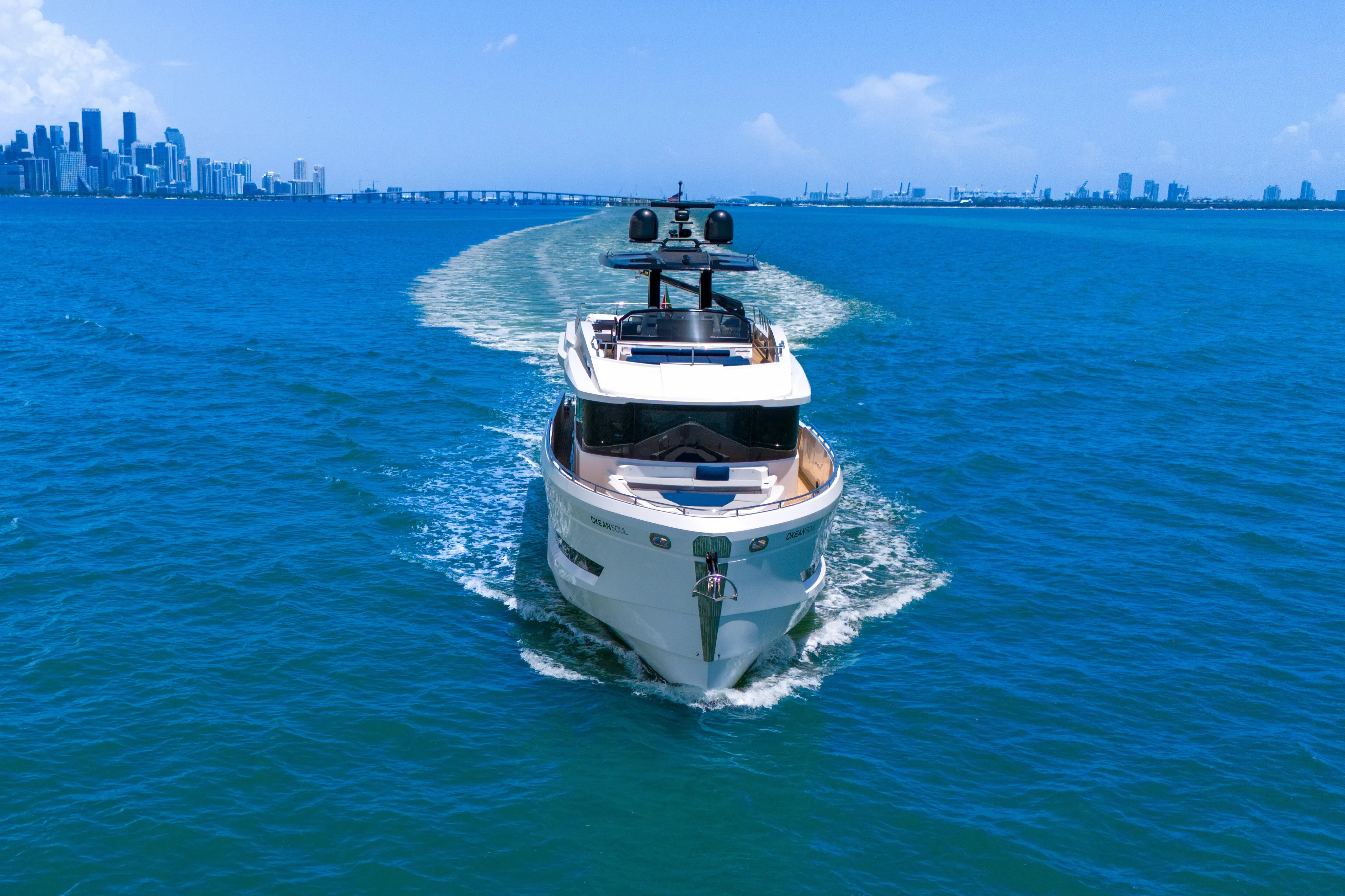  Yacht Photos Pics Luxury OKEAN 80 yacht cruising in blue ocean near city skyline, 2021 model.