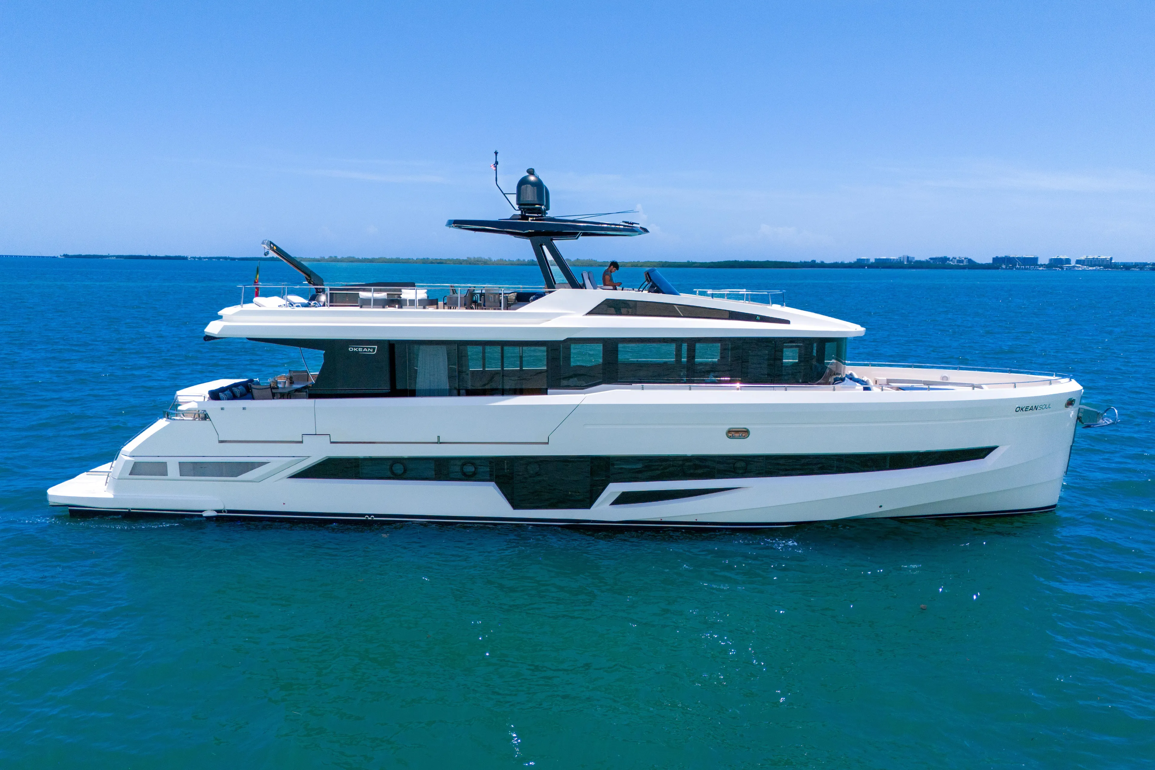  Yacht Photos Pics Luxurious 2021 OKEAN 80 yacht cruising on clear blue ocean waters.