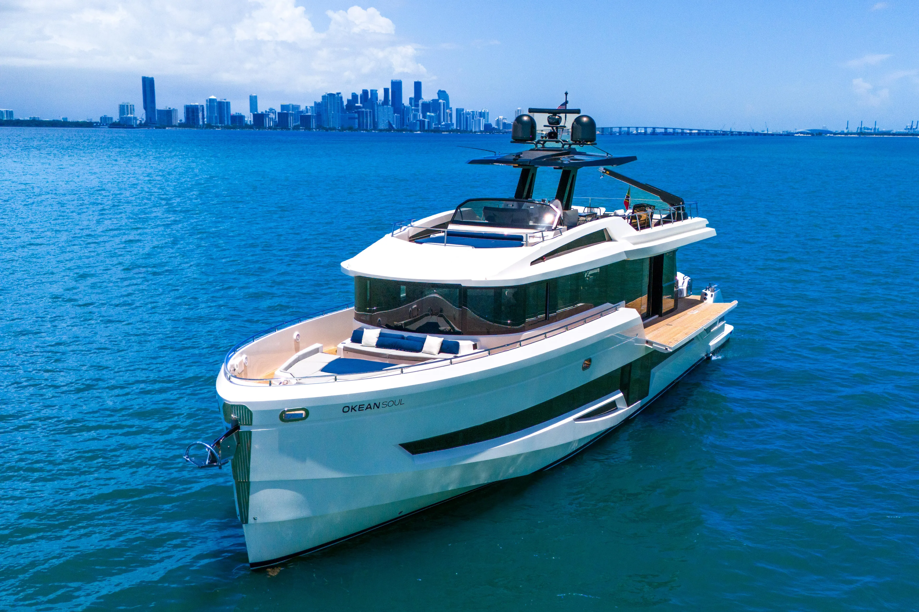  Yacht Photos Pics Luxury 2021 OKEAN 80 yacht on blue ocean with city skyline in background.