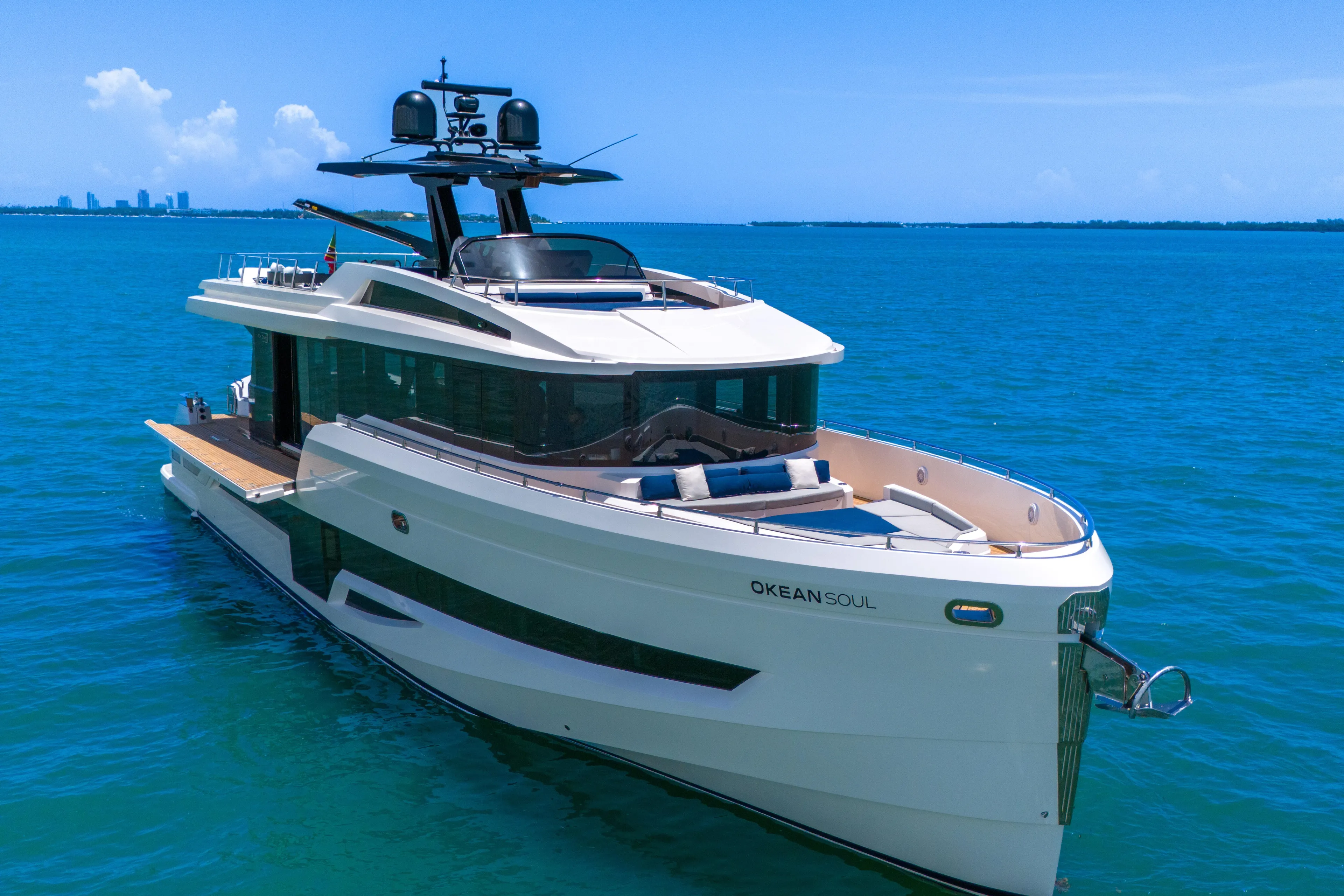  Yacht Photos Pics Luxurious 2021 OKEAN 80 yacht cruising on clear blue waters under a sunny sky.