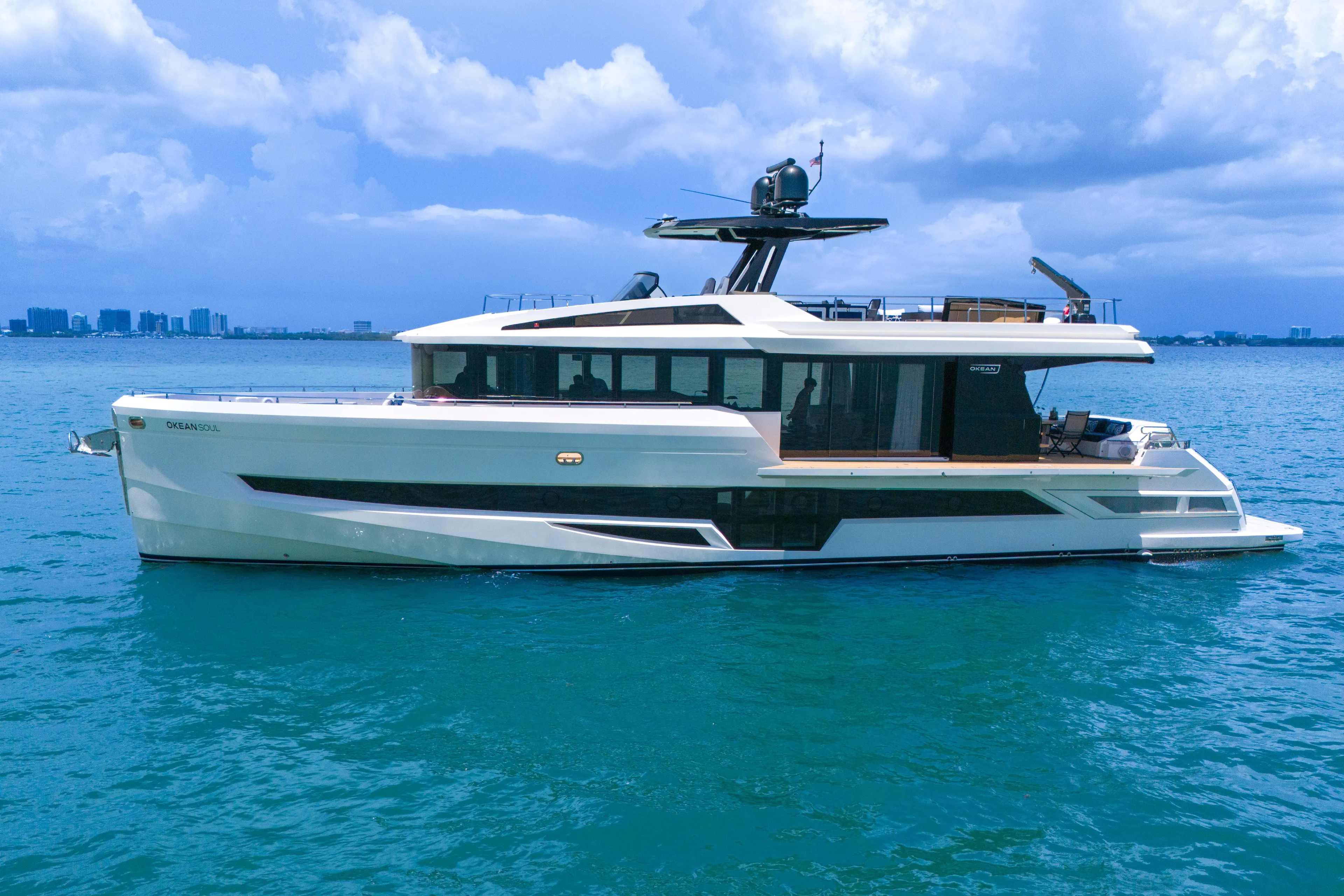  Yacht Photos Pics Luxury 2021 OKEAN 80 yacht on blue ocean with city skyline background.