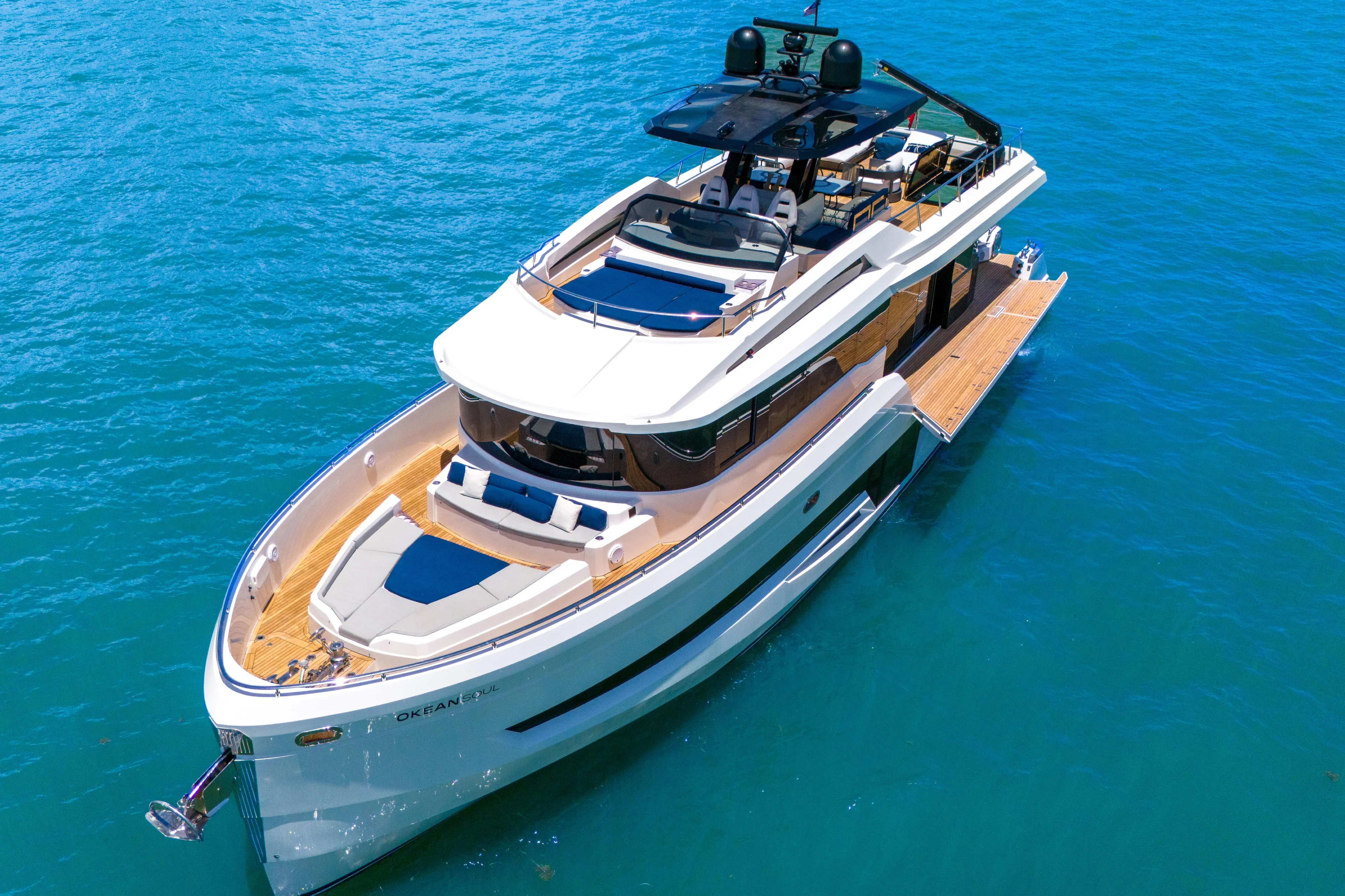  Yacht Photos Pics Luxury 2021 OKEAN 80 yacht on clear blue water, showcasing sleek design and spacious deck.