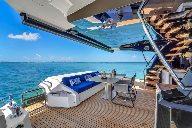  Yacht Photos Pics Luxurious 2021 OKEAN 80 yacht deck with seating, table, and ocean view.