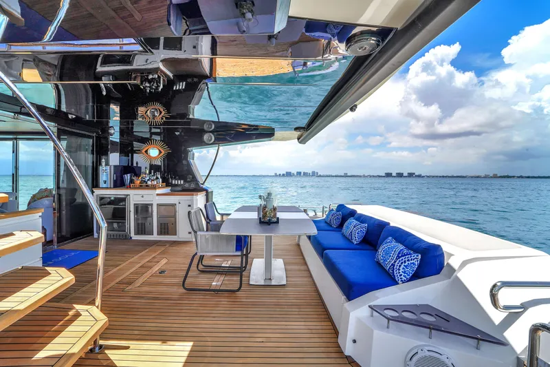  Yacht Photos Pics Luxurious 2021 OKEAN 80 yacht deck with blue seating, ocean view, and modern amenities.