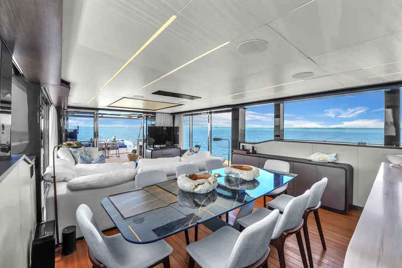  Yacht Photos Pics Luxurious interior of 2021 OKEAN 80 yacht with ocean view, modern dining area, and elegant decor.