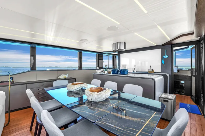  Yacht Photos Pics Luxurious interior of 2021 OKEAN 80 yacht with modern dining area and ocean views.