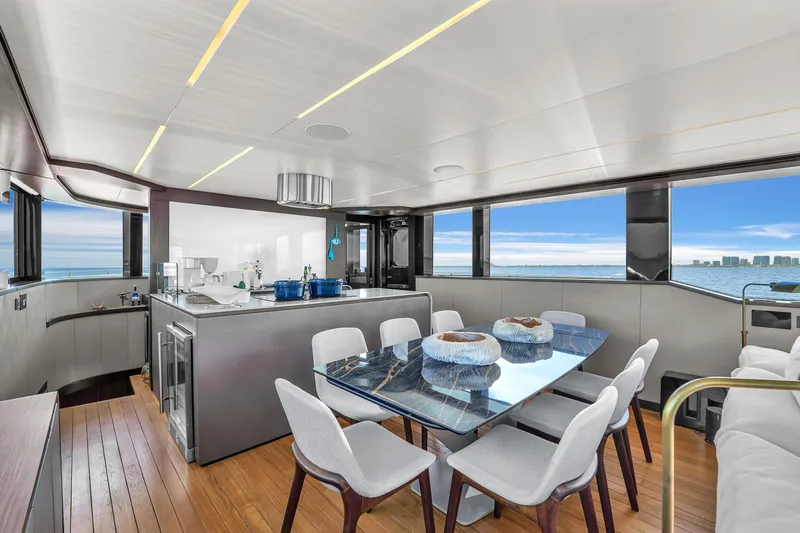  Yacht Photos Pics Luxurious interior of 2021 OKEAN 80 yacht with modern dining area and ocean view.