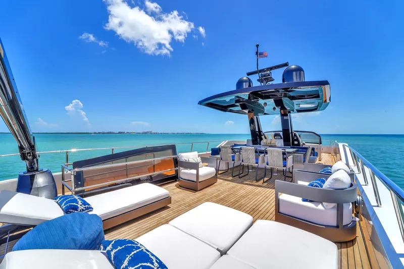  Yacht Photos Pics Luxurious 2021 OKEAN 80 yacht deck with seating, ocean view, and clear blue sky.