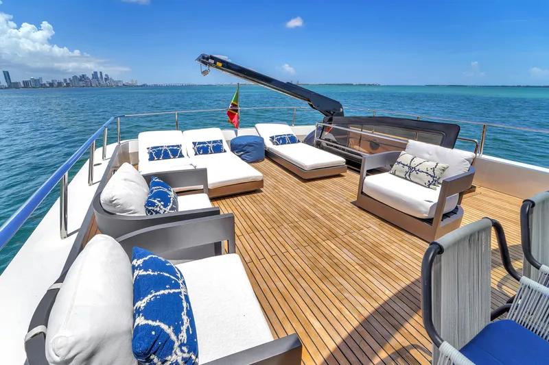  Yacht Photos Pics Luxurious 2021 OKEAN 80 yacht deck with stylish seating, ocean view, and city skyline.