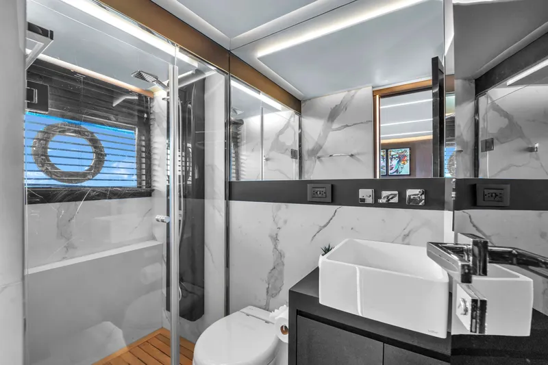  Yacht Photos Pics Luxurious bathroom on 2021 OKEAN 80 yacht with modern fixtures and marble accents.