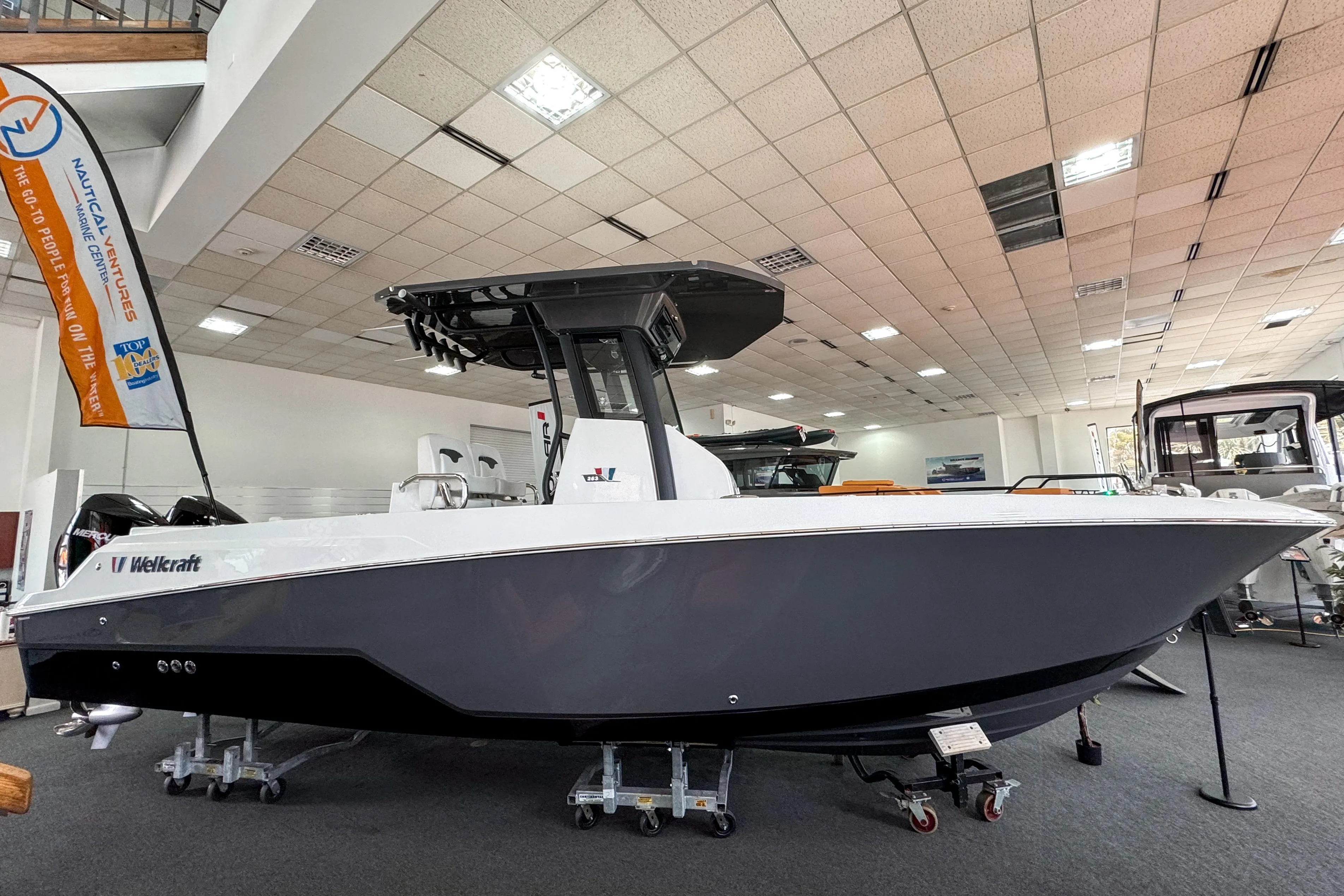 2024 Wellcraft 263 Fisherman boat displayed in showroom, side view.