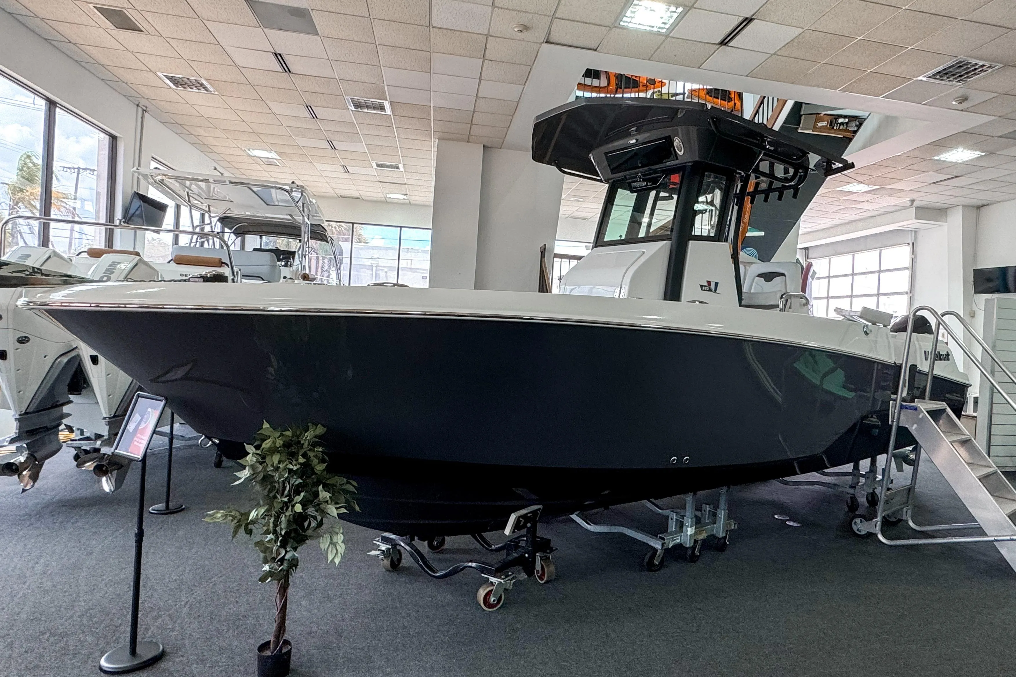 2024 Wellcraft 263 Fisherman boat displayed in a showroom, featuring sleek design and modern amenities.