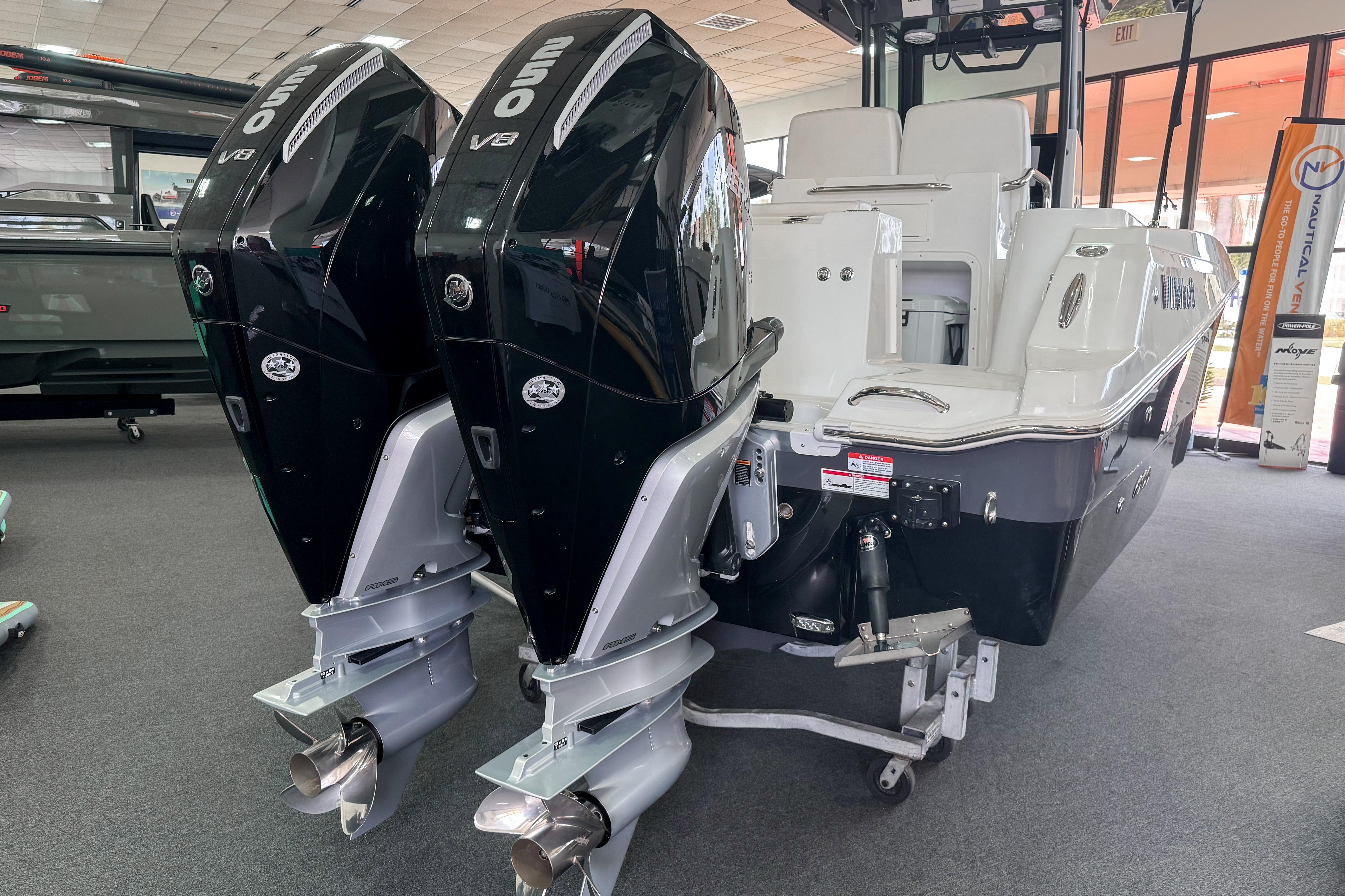 2024 Wellcraft 263 Fisherman boat with dual 250 V8 engines displayed indoors.