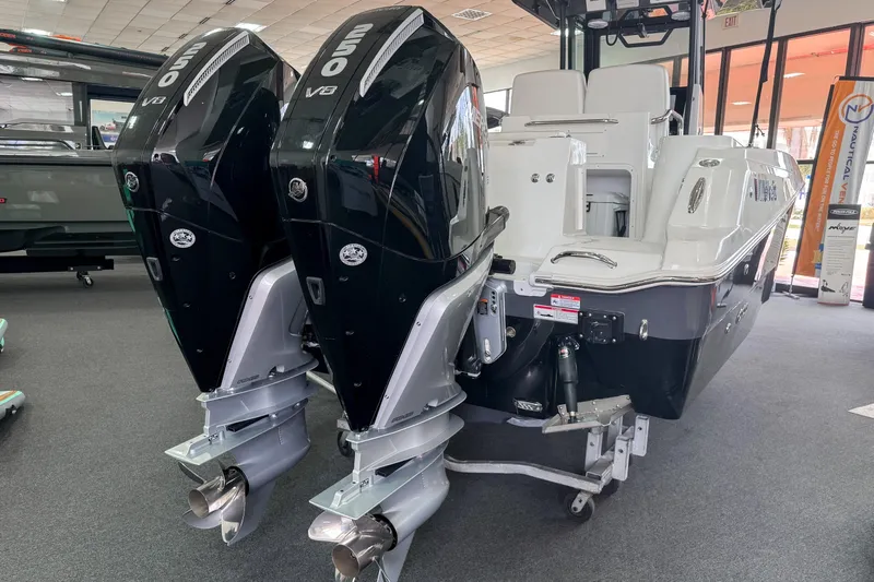  Yacht Photos Pics 2024 Wellcraft 263 Fisherman boat with dual 250 V8 engines displayed indoors.