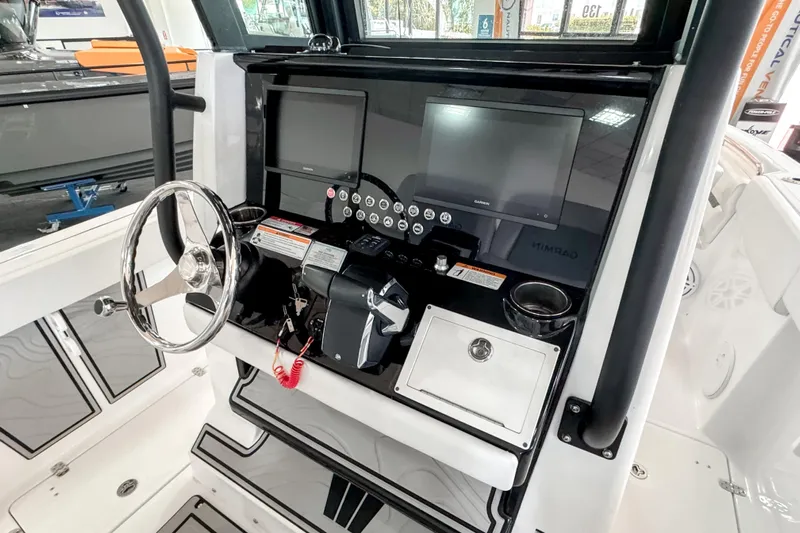  Yacht Photos Pics 2024 Wellcraft 263 Fisherman boat dashboard with steering wheel and navigation screens.