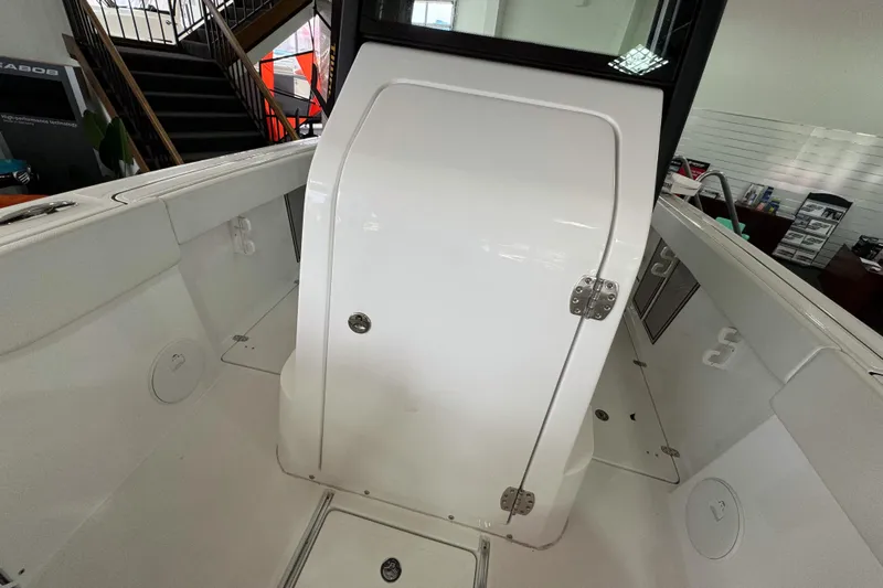  Yacht Photos Pics 2024 Wellcraft 263 Fisherman boat interior, featuring a white cabin door and sleek design elements.