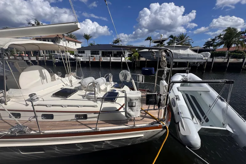 Entertainer Yacht Photos Pics 1989 Little Harbor Sloop 58' docked, featuring a spacious deck and inflatable dinghy.