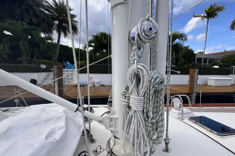 Entertainer Yacht Photos Pics 1989 Little Harbor Sloop - 58' sailboat mast with rigging, docked near palm trees.