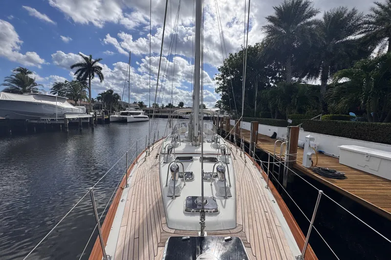 Entertainer Yacht Photos Pics 1989 Little Harbor Sloop 58' docked, surrounded by palm trees and a clear blue sky.