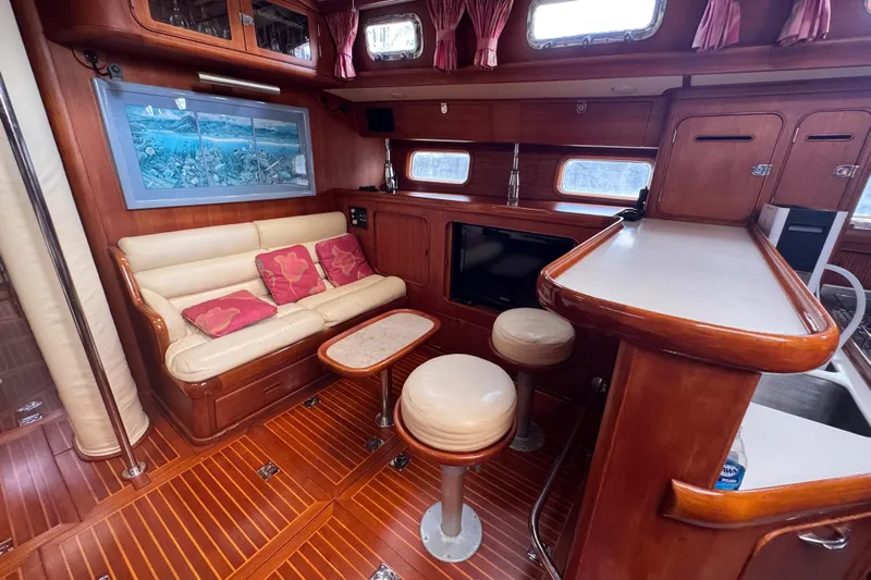 Entertainer Yacht Photos Pics Luxurious 1989 Little Harbor Sloop interior with elegant wood finish and cozy seating area.