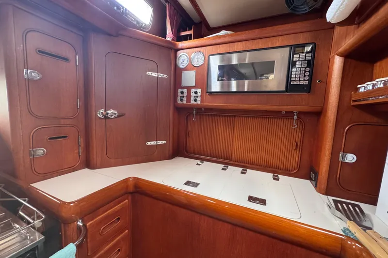 Entertainer Yacht Photos Pics Wooden interior of 1989 Little Harbor Sloop 58' with microwave and storage cabinets.