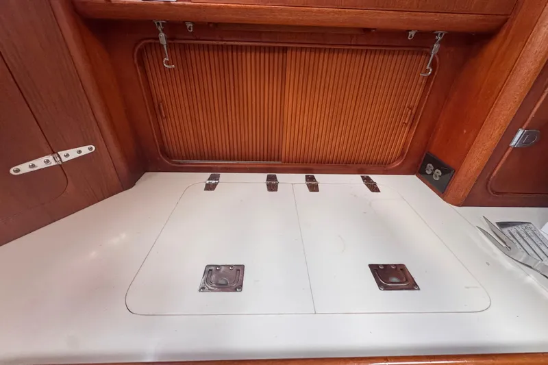 Entertainer Yacht Photos Pics Interior of 1989 Little Harbor Sloop 58' with wooden cabinetry and storage compartments.