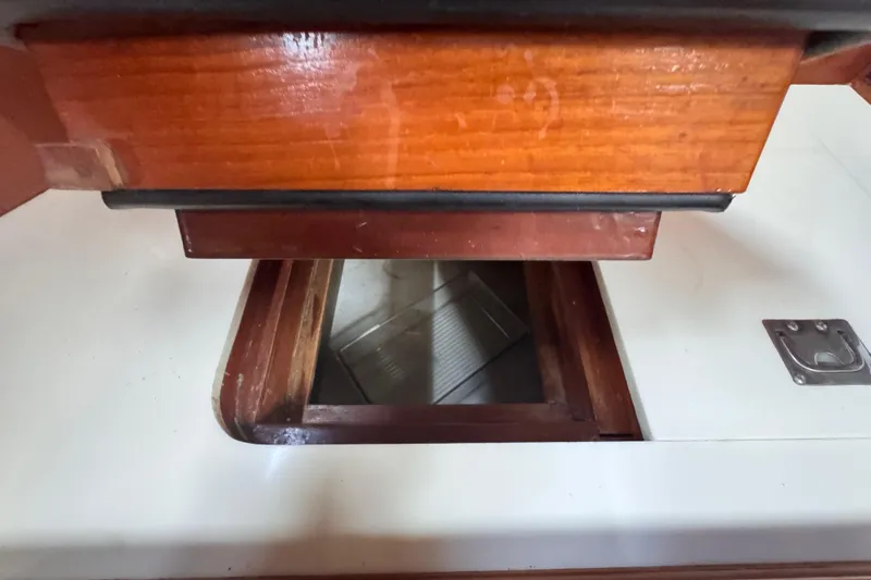 Entertainer Yacht Photos Pics Interior view of 1989 Little Harbor Sloop 58', featuring wooden cabinetry and storage compartment.