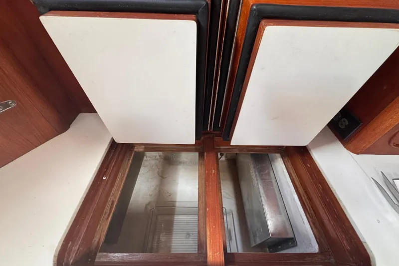 Entertainer Yacht Photos Pics Interior view of 1989 Little Harbor Sloop 58' with wooden cabinetry and storage compartments.