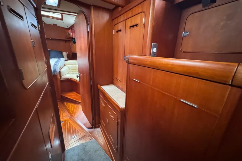 Entertainer Yacht Photos Pics Interior of 1989 Little Harbor Sloop 58' with wooden cabinetry and cozy seating area.