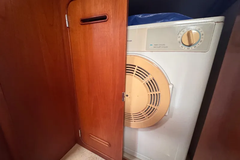 Entertainer Yacht Photos Pics Laundry area inside 1989 Little Harbor Sloop 58', featuring a compact dryer.