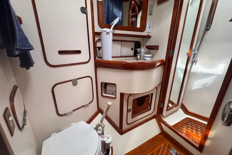 Entertainer Yacht Photos Pics 1989 Little Harbor Sloop 58' bathroom with wooden accents and compact design.