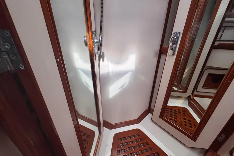 Entertainer Yacht Photos Pics 1989 Little Harbor Sloop 58' interior with wooden accents and mirrored surfaces.