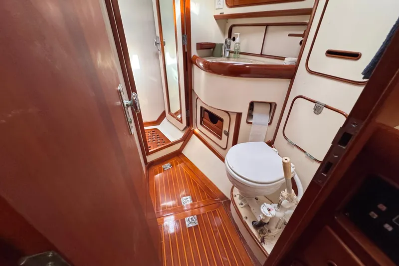 Entertainer Yacht Photos Pics Luxurious 1989 Little Harbor Sloop 58' yacht bathroom with wooden accents and modern amenities.