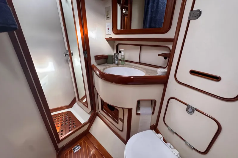 Entertainer Yacht Photos Pics Luxurious 1989 Little Harbor Sloop 58' bathroom with elegant wood accents and modern amenities.