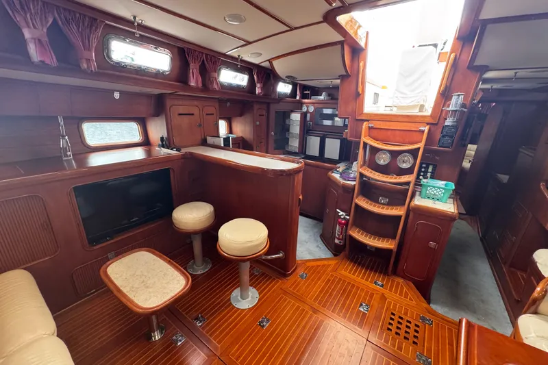 Entertainer Yacht Photos Pics Luxurious 1989 Little Harbor Sloop 58' interior with elegant wood finish and seating area.