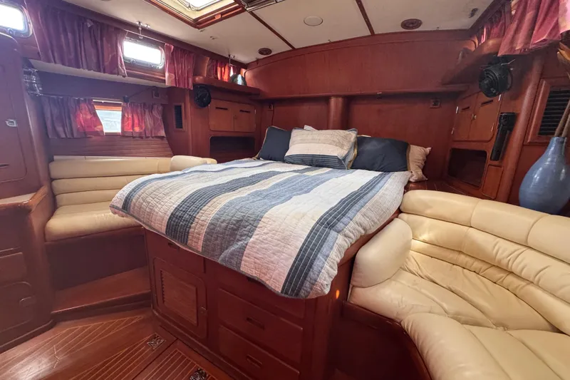 Entertainer Yacht Photos Pics Luxurious cabin interior of 1989 Little Harbor Sloop 58' with cozy bed and seating.