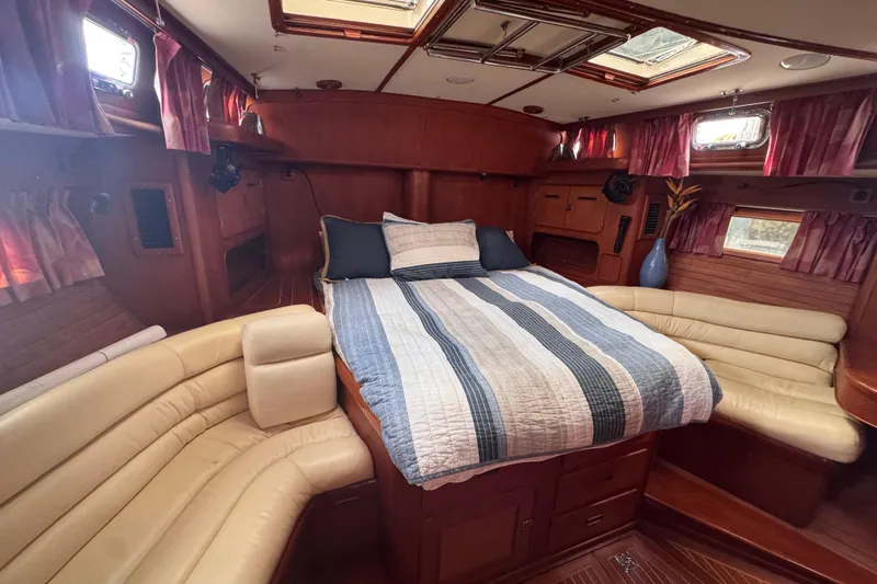 Entertainer Yacht Photos Pics Luxurious interior of 1989 Little Harbor Sloop 58' with cozy bed and seating area.