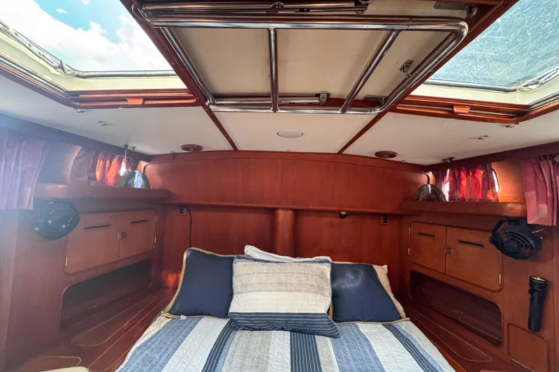 Entertainer Yacht Photos Pics Cozy cabin interior of 1989 Little Harbor Sloop 58', featuring wood paneling and skylights.